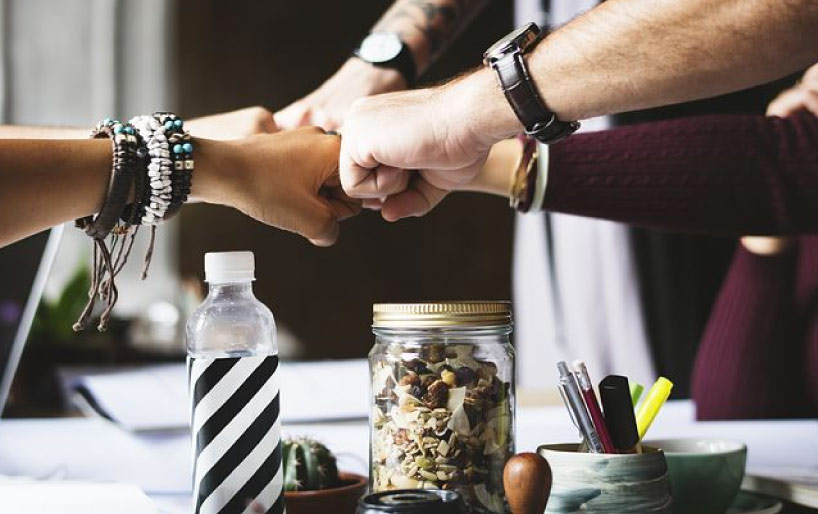 team building image with hands joined at fists